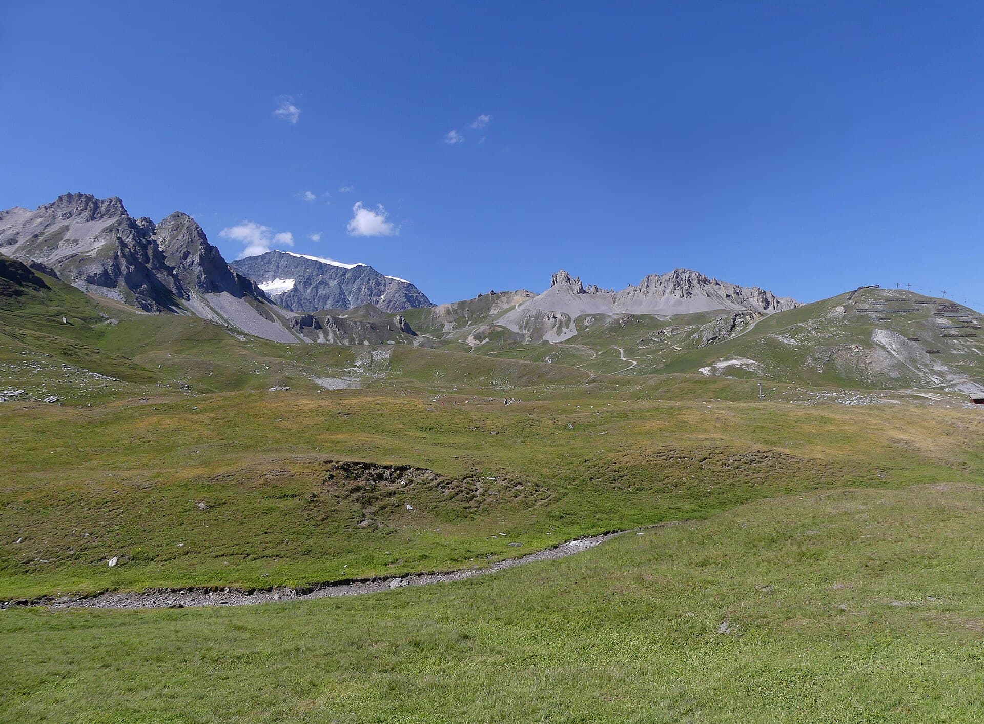 Haute cime enneigée embrasée par le lever du soleil au-dessus des nuages